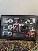 Photo of the framed EMI Music Canada collectible featuring CDs and artist photos.