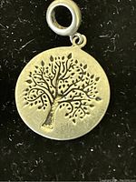 Front side of the pendant showing tree of life design