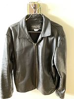 Front view of men's black leather jacket by Cosa Nostra featuring zipper closure and shirt collar