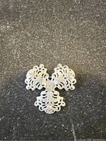 Front side of the vintage silver brooch showing detailed filigree ornamental design