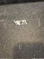 Photo of the front of the vintage silver brooch showing music staff and notes design