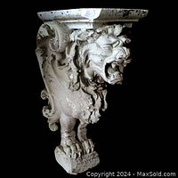 Front and left side view of the weathered griffin wall sconce showing full form, size and surface weathering.