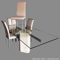 Full view of the dining table with clear glass top and four upholstered chairs around it