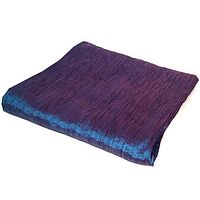 Folded pleated taffeta fabric showing the turquoise and indigo color blend with rippled texture