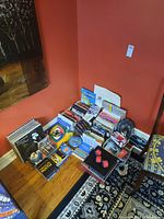 Wide view of all items including LPs, books, games, snorkel gear scattered on floor and against wall