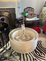 Overhead view of the ceiling light fixture showing the interior with three bulb holders and the fabric outer shade.