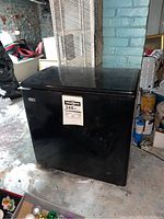 Full view of black Danby Premiere chest freezer showing front and top lid.