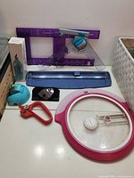 Image of arts and crafts tools including paper cutters, measuring tools, and a rotary tool.