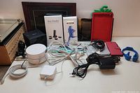 Full overview of lot showing all electronics, cables, and accessories arranged on table