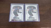 Two Bowen Byram Allure rookie hockey cards in protective cases, showing front side with player image and branding.