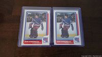 Two John Vanbiesbrouck rookie hockey cards in protective cases.