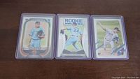 Three Nate Pearson rookie baseball cards in protective holders on a flat surface.
