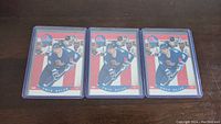 Three identical Owen Nolan rookie hockey cards in blue Quebec Nordiques uniform each encased in a hard plastic protective sleeve.