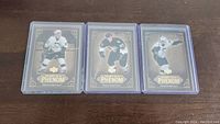 Three Sidney Crosby rookie hockey cards displayed in protective cases, front view showing card designs