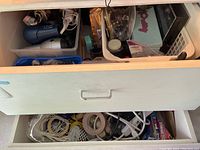 Second drawer with extension cords, power strips, storage wrap, and miscellaneous small items.