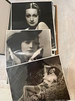 Group of three black-and-white portraits in plastic sleeves.