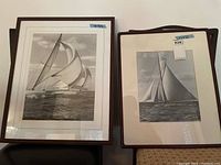 Front view of two framed black and white sailing prints, showing the full artwork and framing details.