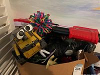 Wall-E robot figure, Godzilla dinosaur figure, Fortnite Nerf blaster, expandable ball toy in cardboard box