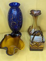 Full view of all four art glass vases showing variety in shape and color.
