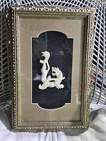 Full view of the mounted and framed carved stone tiger figurine with ornate frame and glass cover.