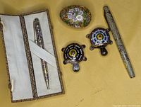 Photo showing the full set including cloisonne ballpoint pen in box, fountain pen, two turtle trinket boxes, and cloisonne egg decor.