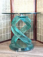 Front view of glass side table showing spiral base and circular top