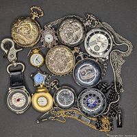 Assortment of pocket watches and novelty mini clocks arranged showing various engraved cases, chains, and clock faces.