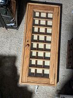 Top view showing the front of the wooden mail sorter with glass door and multiple mail sorting compartments.
