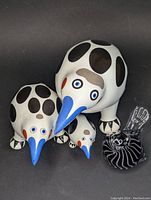 Overview of all four bird figurines including the three ceramic Villeroy & Boch Animal Park birds and the black and white art glass bird.