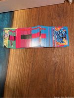 Stack of 1992 Impel Marvel The Uncanny X-Men Series 1 trading cards laid out horizontally on a wooden surface showing card fronts with colorful character artwork.