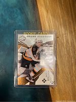 Front of 2003 Upper Deck Black Diamond Rookie Card #184 featuring Patrice Bergeron in Boston Bruins uniform.