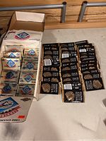 Box of sealed Studio 1991 baseball card and puzzle packs with several packs inside the box and more laid out outside the box.