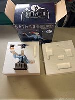 Photo of the Harley Quinn bust in foam packaging with the box behind showing branding and anniversary edition details.