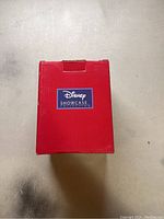 Top view of the closed red box with Disney Showcase Collection label in white and blue.
