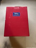 Red box with Disney Showcase logo on top, packaging for the figurine.