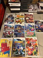 Top down photo showing ten Wii game cases arranged on a table with visible cover art.