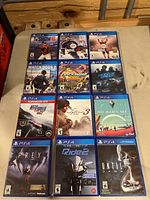 Photo of the front covers of twelve PS4 games arranged in a grid.