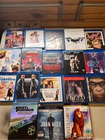 Photo showing all Blu-ray and 4K Ultra HD movie cases laid out on a wooden surface.