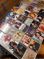 Overview of the 46 CDs laid out showing album artwork of popular artists and albums from late 90s and early 2000s