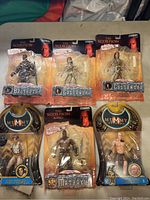 Lot of 6 action figures from The Mummy and The Scorpion King, showing all figures in sealed blister cards including Rick O'Connell, Imhotep, Mathayus, Balthazar, and two Cassandra figures.