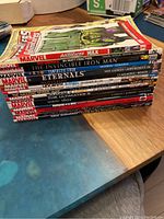 Stack of Marvel softcover graphic novels showing spines with titles and authors.