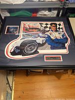 Framed print featuring Max Papis standing next to his Miller Lite race car with checkered flag background and plaque below.