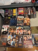 Overview of DVDs and VHS tapes including Hogan's Heroes sets, The Wild Wild West, Lord of the Rings, and others.