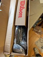Top view of Wilson branded box containing multiple golf clubs individually wrapped in bubble wrap inside the box.