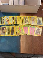 Top-down photo of trading cards laid out on table, showing yellow-bordered cards with character images and scenes from Star Wars The Empire Strikes Back Series 3.