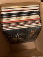 Box filled with vinyl records, front visible cover is 'Bless This House' by Don McLean.