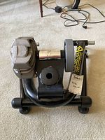 CycleOps bike trainer stand front and top view showing the resistance unit and adjustment knob