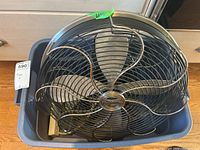 Top view of the metal Casablanca table fan showing the blade guard with a unique wave-style metal grill and the Casablanca logo in the center.