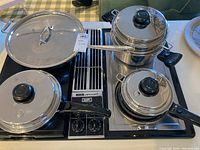 All four pieces arranged on cooktop