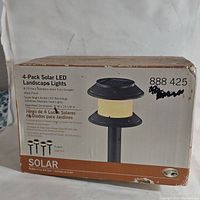 Box of Hampton Bay 4 pack solar LED landscape lights showing product details and wear on the box